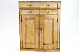 A pine cupboard, of plain rectangular form,