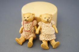 Two 19th century Hertwig bisque teddy bears, painted yellow,