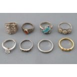 A collection of eight silver rings of variable designs. Size range from K to Q.