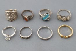 A collection of eight silver rings of variable designs. Size range from K to Q.