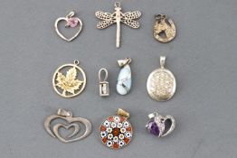 A collection of ten pendants of variable designs,