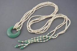 A multi strand freshwater rice pearl necklace and large polished green stone pendant