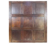 A section of 18th century oak panelling with nine fielded panels,