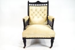 A late Victorian armchair with ebonised frame,