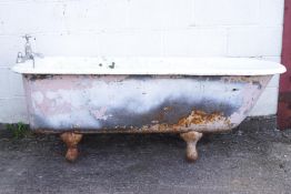 A roll top cast iron bath on four legs 62cm high 164cm long 65cm wide