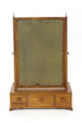 A 19th century mahogany swing frame mirror on rectangular base