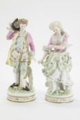 A pair of French bisque figurines in 18th century dress,