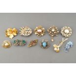 A collection of twenty costume brooches of variable designs.