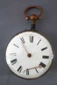 A key wound open face pocket watch. White dial with roman numerals. No key and hands detached.