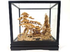 A cork Diorama model, hard wood cased and glazed, depicting a group of pagoda style buildings,