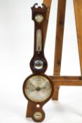 A Victorian mercury wheel barometer by G B Vismari of Bury St Edmunds of typical banjo form with