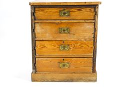 A pine chest of four drawers with brass inset handles,