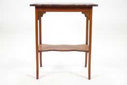 An early 20th century mahogany table with shaped top inlaid with a central satinwood patera