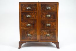 A walnut effect chest of eight drawers, bearing label 'Ingelsants of Leicester' to the top drawer,