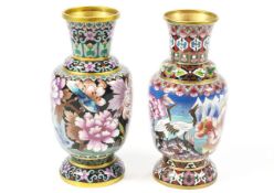 Two cloisonne vases of similar form, one decorated with flowers and birds on a black ground,