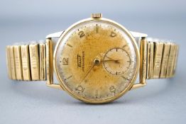 A yellow metal Tissot wristwatch. Manual wind movement. Expanding bracelet. Case back not opened.