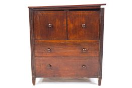 A mahogany commode with plain rectangular hinged lid top over two doors