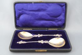 A pair of cased silver Apostle serving spoons with a 3D cast terminal figure of St James