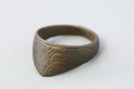 A 11th century base metal Middle Eastern archer's thumb ring with engraved decoration