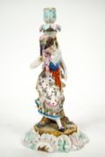 A Continental hard paste porcelain candlestick with a figure of a lady dancing with a fan,