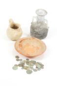 A Roman glass two handled vase, a terracotta bowl, a jug and collection of early coins.