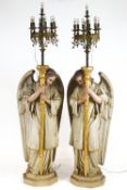 A pair of ceramic torcheres with realistic polychrome painted finish modelled in the forms of