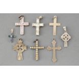 A collection of eight silver cross pendants of variable designs.