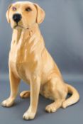 A Beswick figure of a golden labrador, impressed and printed factory marks, Number 231,