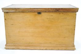 A pine blanket box with two handles and moulded plinth base,