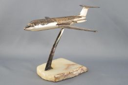 A desk paperweight in the form of a white metal finished model of a BAG 111 aircraft