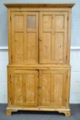 A pine two tier cupboard of plain rectangular form,