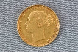 A yellow gold full sovereign coin dated 1884.