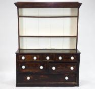A 19th century pine dresser with raised plate rack above three drawers,