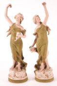 A pair of Royal Dux dancing ladies carrying roses, applied pink pad, impressed Number 2020,