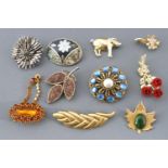 A collection of twenty costume brooches of variable designs.