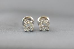 A white metal pair of single stone studs.