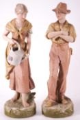 A pair of Royal Dux female figures with a watering can, pink and applied pad,