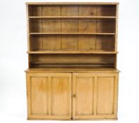 A pine dresser of very plain rectangular form,