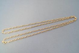 A yellow metal trombone linked chain, 800mm. Bolt ring clasp.