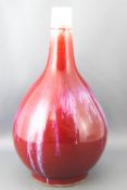 A 20th century Chinese sang de boeuf vase, with narrow tapering neck and baluster body,