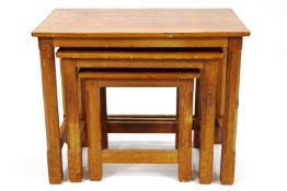 A nest of three oak 'rabbit man' tables, of plain rectangular form,