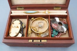 A jewellery case consisting of multiple items of costume jewellery and watches,