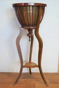 An Edwardian mahogany planter with brass liner in a ribbed support,