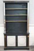 A black and gold finished hardwood Egyptian Revival bookcase with a star set cornice