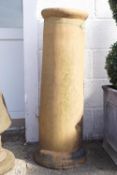 An earthenware cylindrical chimney pot,