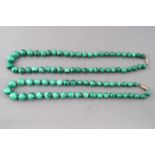 A collection of two graduated strands of malachite beads.