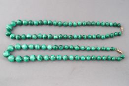 A collection of two graduated strands of malachite beads.