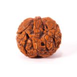 A Chinese carved walnut, decorated with figures and tigers in a rocky landscape,