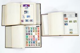 Three Ajax stamp albums of British and world stamps,