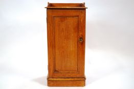 A pine pot cupboard with a shelf and wooden gallery,
